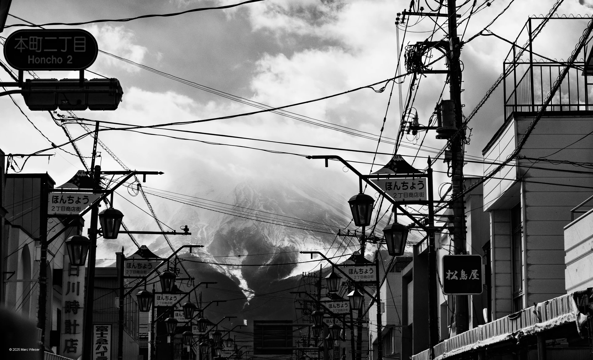 Photo en noir et blanc du Mont fuji dans une rue d’un village Japonais